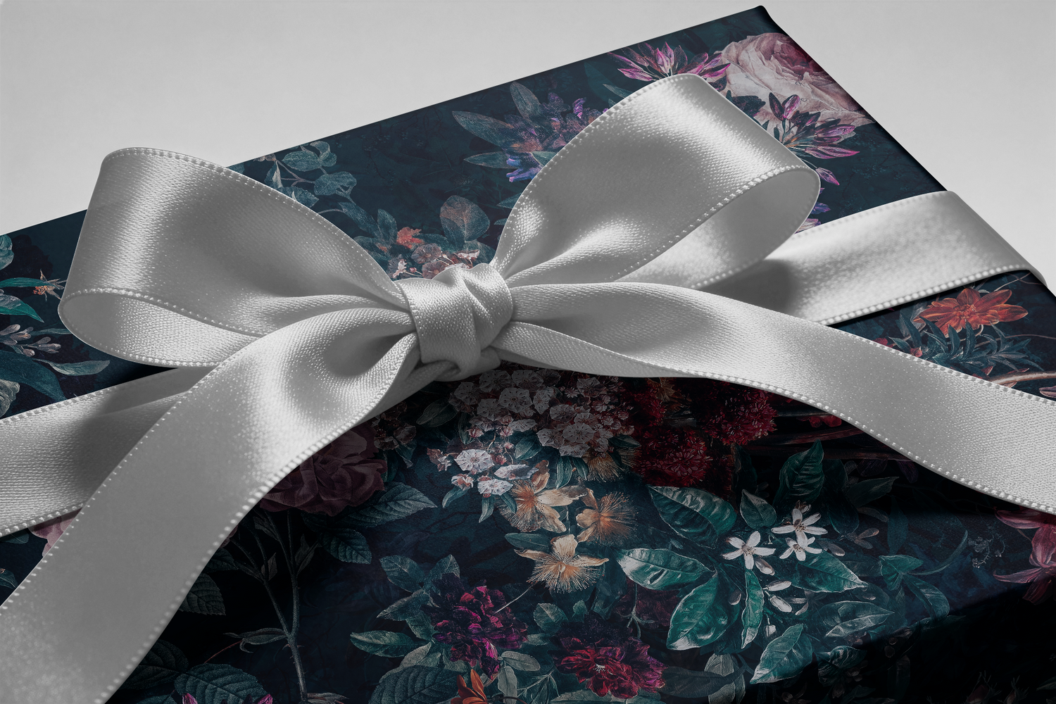 Alt Tag: Moody Floral Christmas Wrapping Paper Velvet Noir with jewel-toned burgundy plum rose and emerald florals on midnight backdrop, satin bow