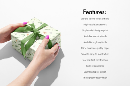 Floral Wrapping Paper Conservatory Bloom on gift box with green ribbon, showcasing sage background with lilies, peach blossoms and greenery