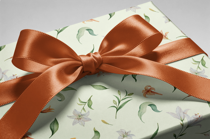 Alt Tag: Floral Wrapping Paper on gift box with sage background, lilies and peach blossoms, finished with a copper satin ribbon bow