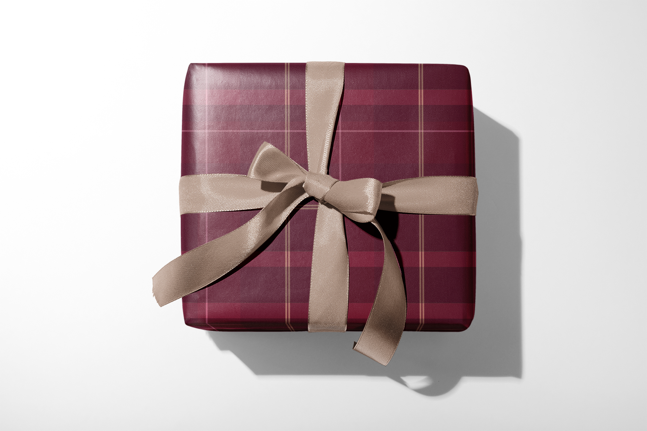 Alt Tag: Burgundy Plaid Wrapping Paper in manor tartan burgundy plaid with fine gold lines, wrapped gift with beige ribbon bow