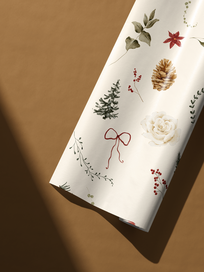 Alt Tag: Winter Garden botanical Christmas wrapping paper with watercolor pinecone, holly, evergreen sprigs, ornaments and bow on cream backdrop