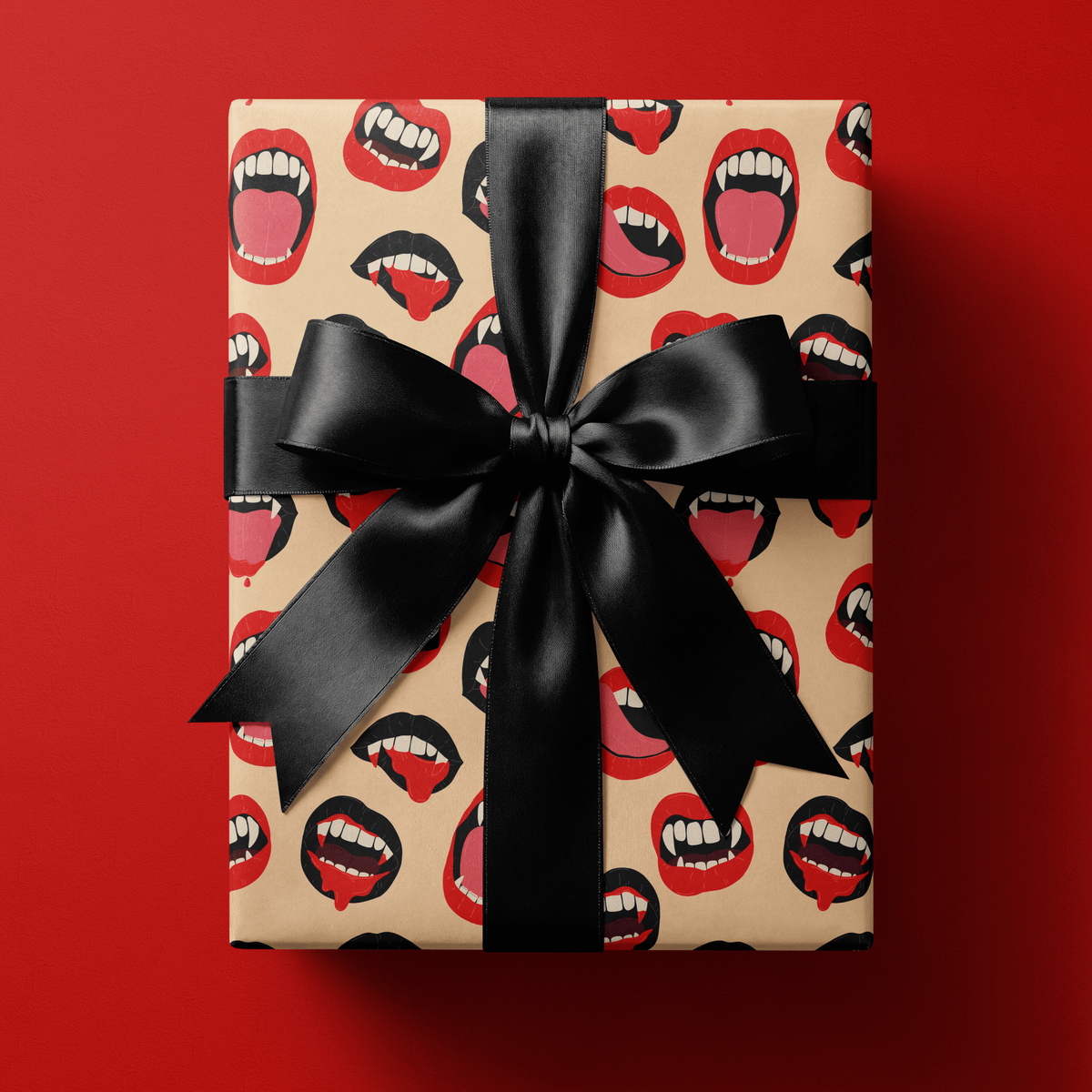 Goth wrapping paper with red and black open vampire mouths and fangs on a nude blush ground