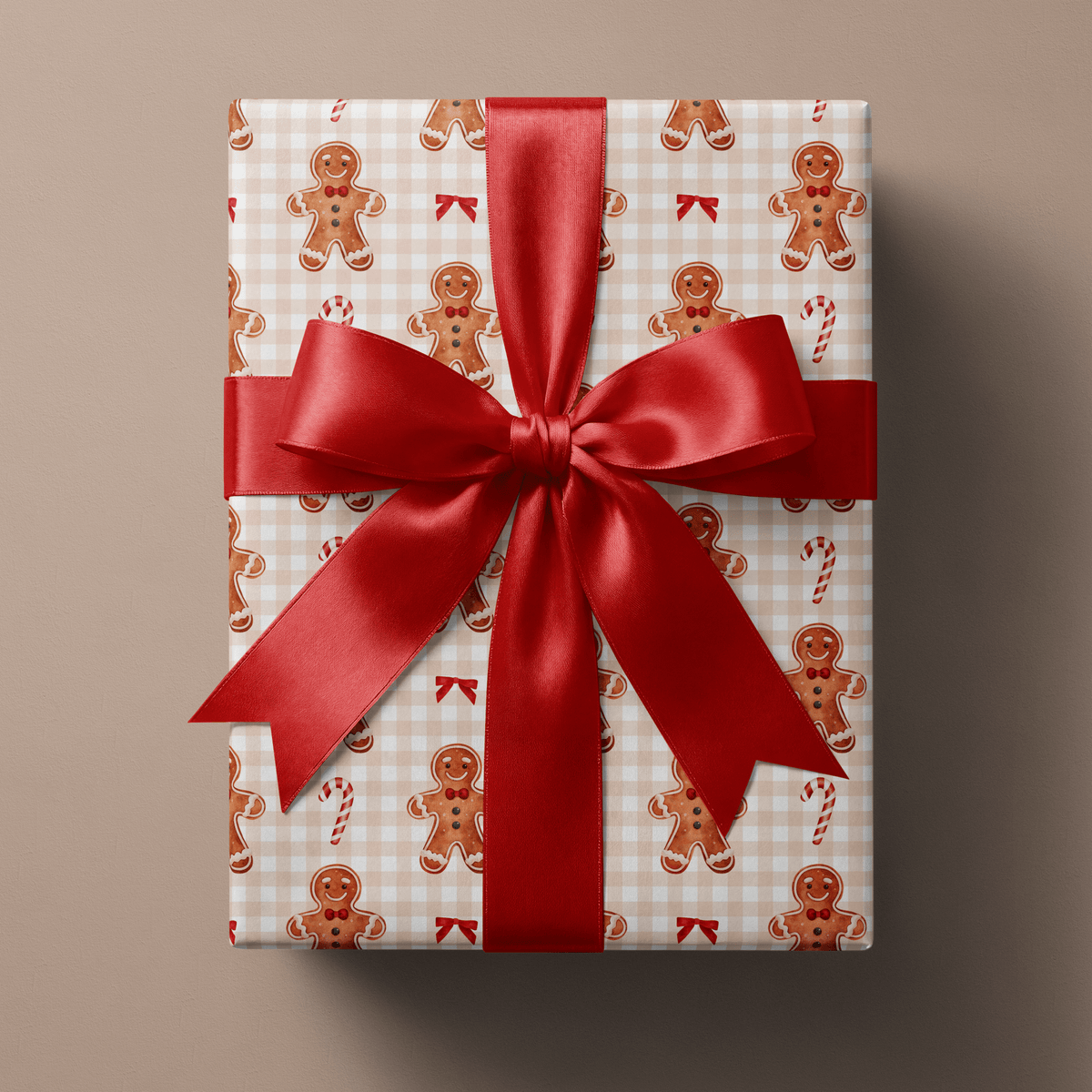 Gingerbread Christmas wrapping paper with watercolor gingerbread men, candy canes and red bows on soft tan gingham.