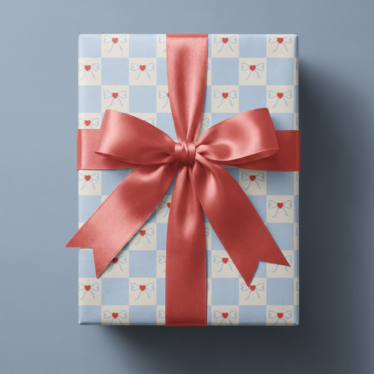 Checkerboard wrapping paper with cream bows and red hearts on powder blue squares.