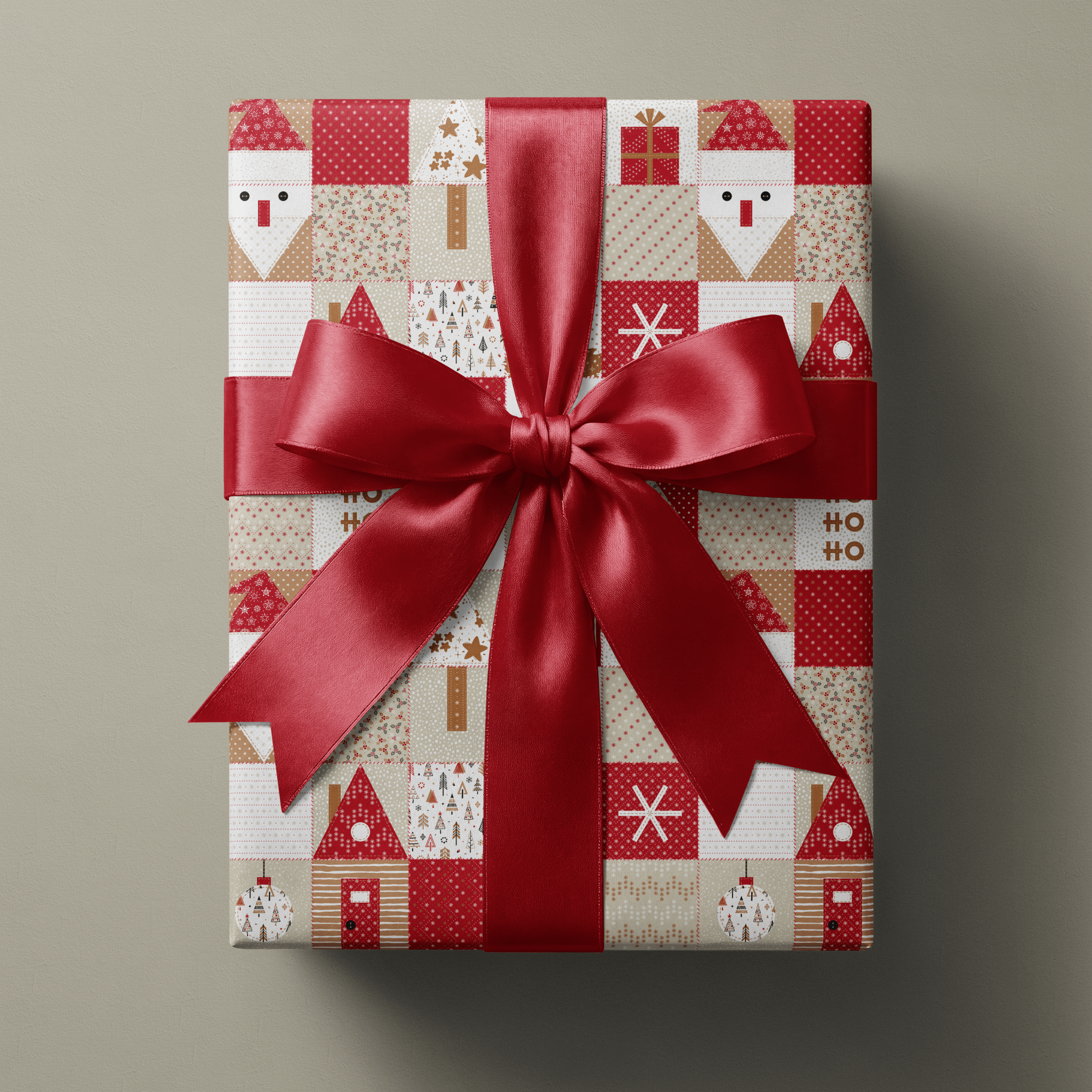 Rustic christmas wrapping paper with patchwork Santas, gingerbread houses, and star quilt blocks in red and cream.