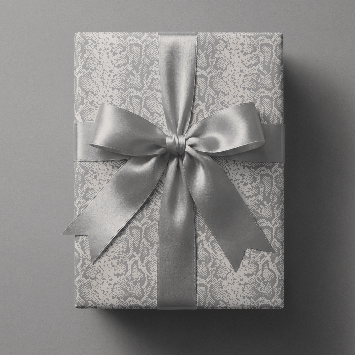 Snakeskin wrapping paper with tonal python texture in soft grey and ivory.