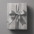Snakeskin wrapping paper with tonal python texture in soft grey and ivory.