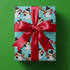 Christmas snowman wrapping paper with a top-hatted snowman ice skating on turquoise.