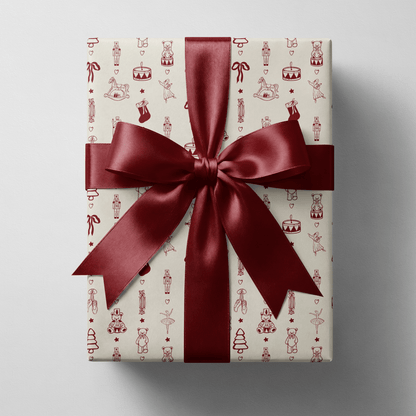 Toy soldier wrapping paper with nutcrackers, rocking horses and ballerinas in cream and burgundy — nostalgic, collectible and ready to wrap under the tree.