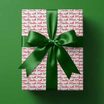 Wrapping paper from Santa in playful red script on white — the easiest way to keep gifts "from Santa" convincing, right down to the paper.