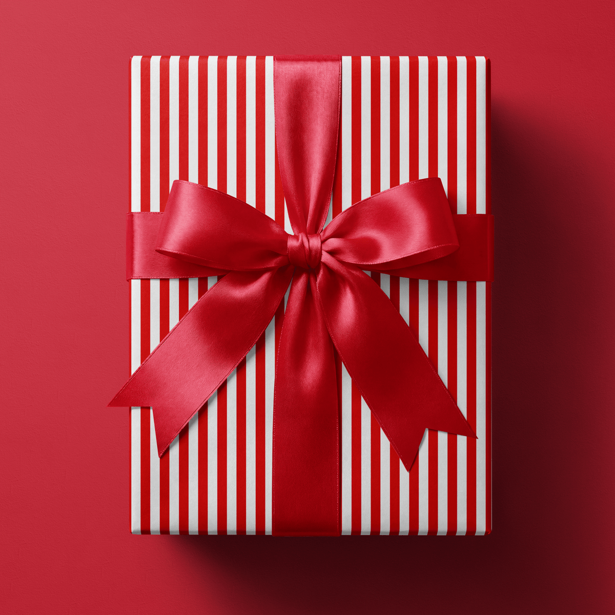 Candy cane stripe wrapping paper with even red and white vertical stripes.