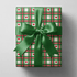 Plaid christmas wrapping paper with hand-drawn green and red lines and small red hearts.
