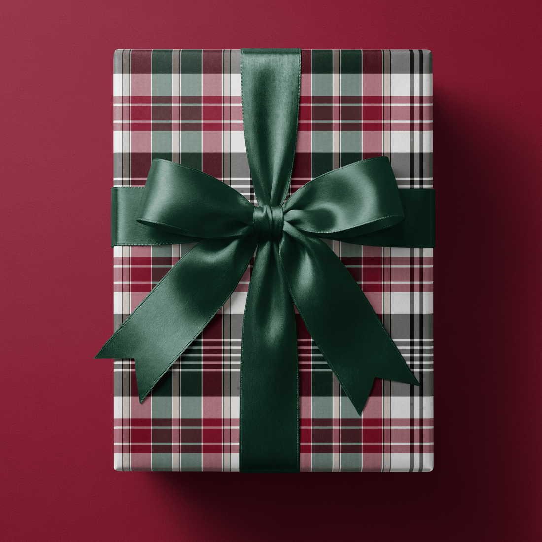 Christmas plaid wrapping paper with a fine wine, green, pink, and sage tartan weave.