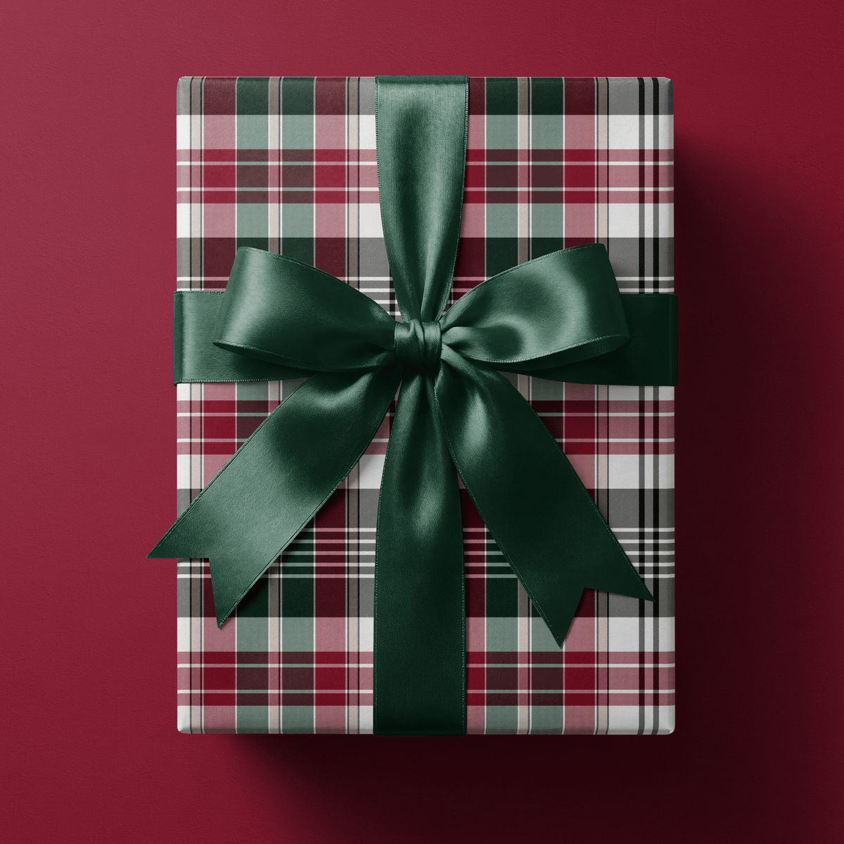 Christmas plaid wrapping paper with a fine wine, green, pink, and sage tartan weave.