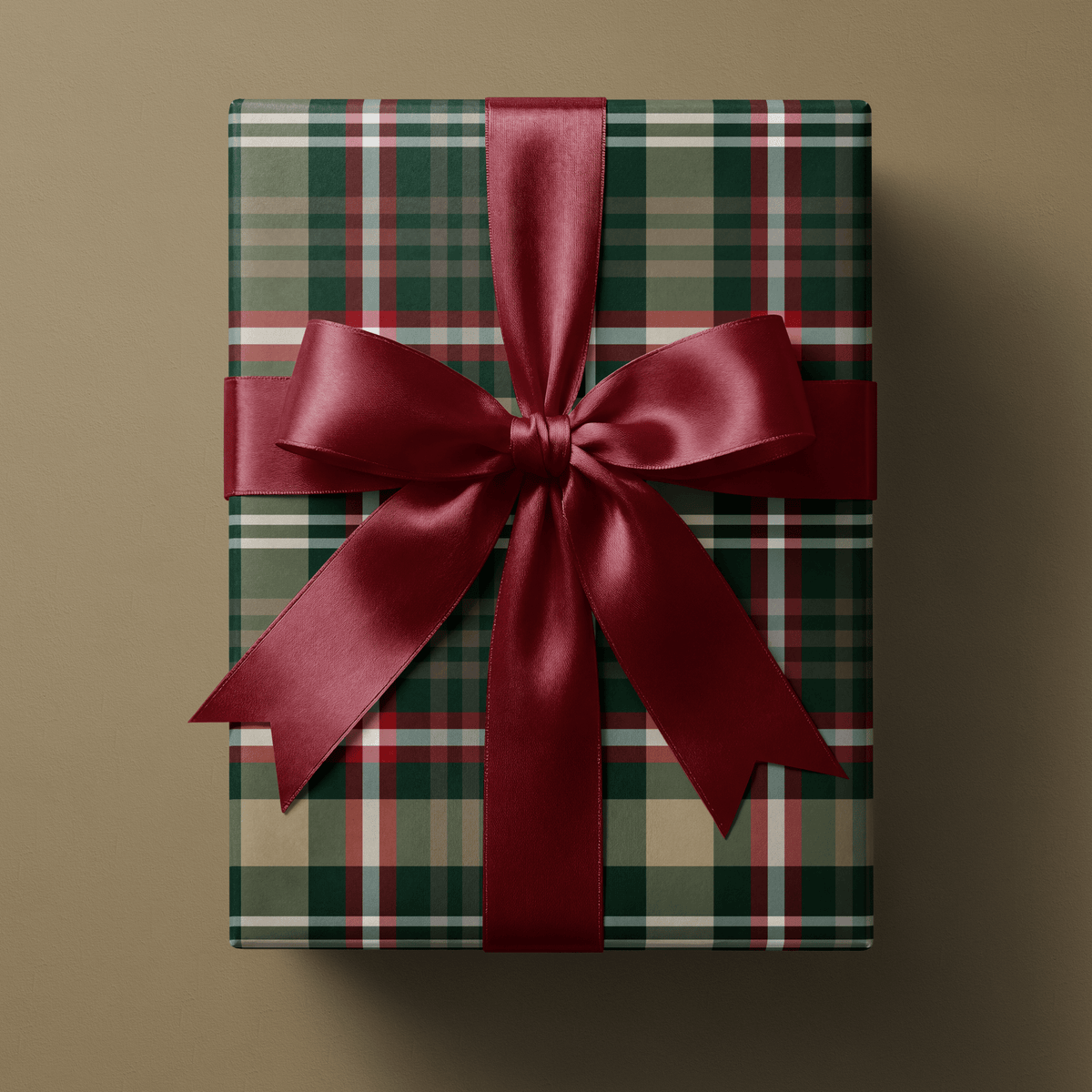 Gift wrapped in Evergreen Tradition buffalo plaid christmas wrapping paper, tied with a black ribbon bow
