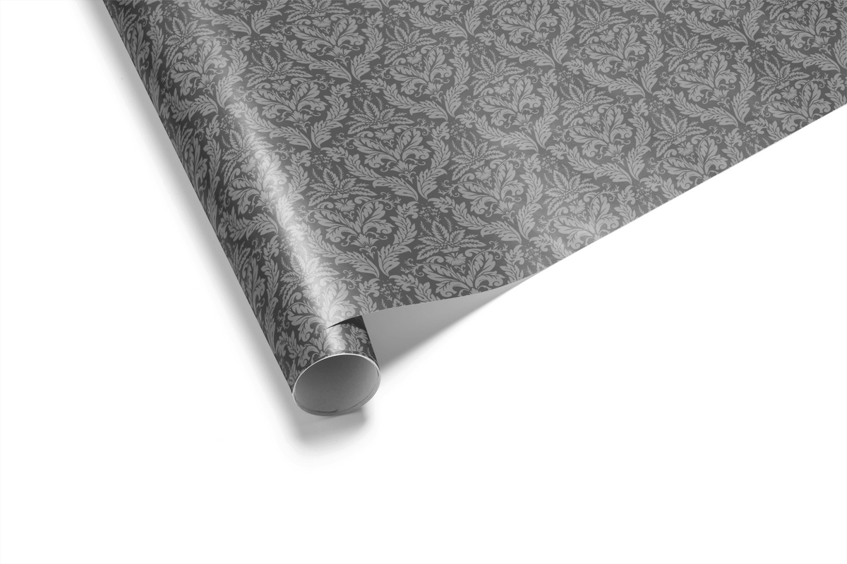 Roll of grey damask victorian wrapping paper standing at an angle