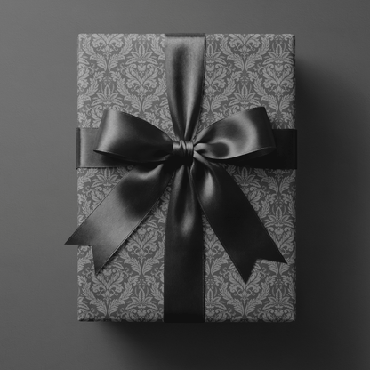 Gift wrapped in grey victorian wrapping paper with a black ribbon bow