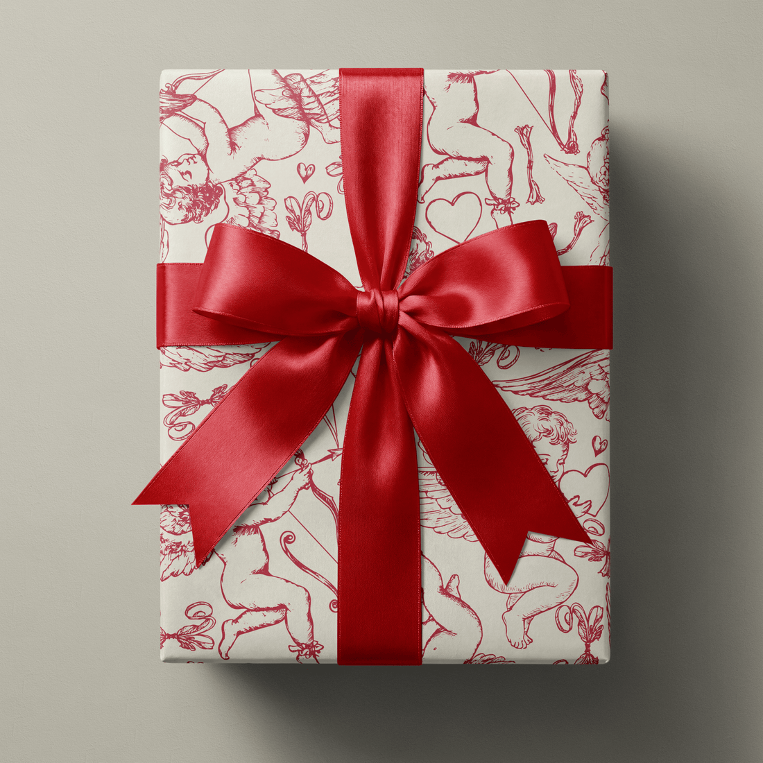 Haus of Wrap romantic cherub toile wrapping paper with red ribbon, perfect for wedding, birthday, and holiday gift wrap.
