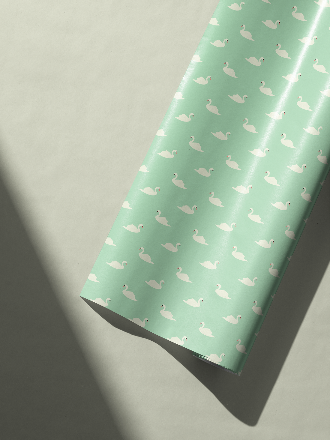 Alt Tag: Elegant Wedding Gift Wrap in soft sage green with repeating white swan pattern, romantic refined wedding present wrapping paper