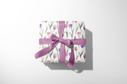 Alt Tag: Floral Gift Wrap with watercolor tulips in pink and lavender on white, wrapped gift box tied with purple ribbon