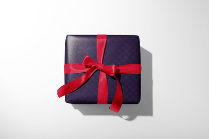 Alt Tag: Gucci-style Infinity Heart Gift Wrap on navy monogram designer gift wrap, wrapped gift box with red ribbon bow