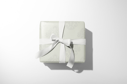 Alt Tag: Bridal Shower Gift Wrap in soft ivory damask pattern with white ribbon, elegant bridal shower gift wrapping paper