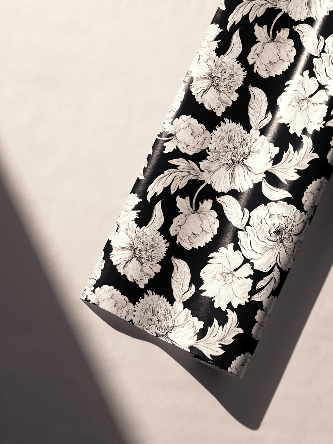 Alt Tag: Black and White Floral Wrapping Paper roll with ivory peonies and botanical leaves on deep black background