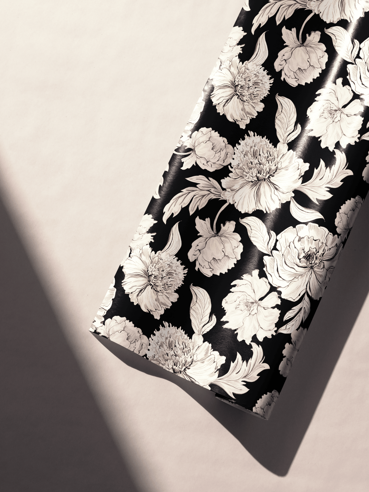 Alt Tag: Black and White Floral Wrapping Paper roll with ivory peonies and botanical leaves on deep black background