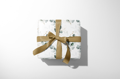 Wedding Gift Wrap in muted sage botanical print with subtle gold detailing and golden ribbon bow, modern bridal gift presentation