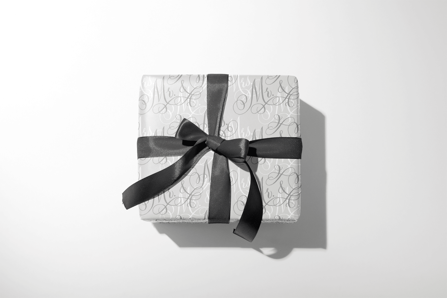 Wedding Wrapping Paper Vows In Starlight with Mr. &amp; Mrs. calligraphy pattern on neutral gift wrap, wrapped box with black ribbon