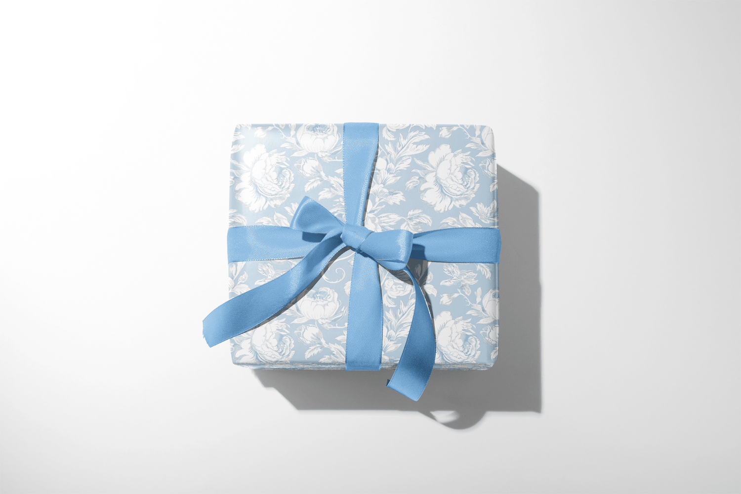 Alt Tag: Baby Shower Gift Wrap in baby blue Wisteria Silk paper with ivory peony botanical print and matching blue ribbon